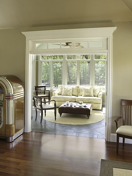 a living room filled with furniture and a fire place next to a doorway that leads to a patio