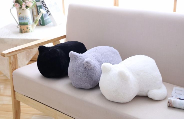 three stuffed animals are sitting on a couch