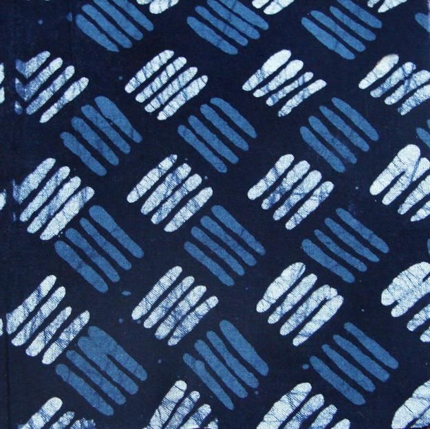 a blue tie with white and black designs on the front, along with dark blue background