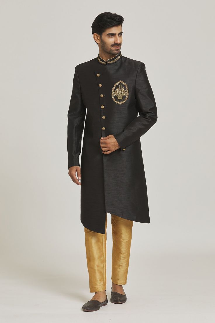 Black overlap sherwani with placement floral embroidery. Paired with chickoo aligarhi pant.
Components: 2
Pattern: Embroidered
Type Of Work: Floral
Neckline: Mandarin
Sleeve Type: Full
Fabric: Sherwani: Art Silk, Pant: Dupion Art Silk
Color: Black
Other Details: 
Asymmetric button placket
Occasion: Sangeet - Aza Fashions Traditional Bandhgala For Reception During Diwali, Reception Sets With Naqshi In Traditional Drape, Festive Kurta With Naqshi For Reception, Designer Resham Embroidery Kurta For Reception, Traditional Black Bandhgala With Resham Embroidery, Formal Salwar Kameez With Dabka In Traditional Drape, Formal Raw Silk Churidar With Resham Embroidery, Designer Sherwani With Straight Kurta For Reception, Designer Raw Silk Kurta