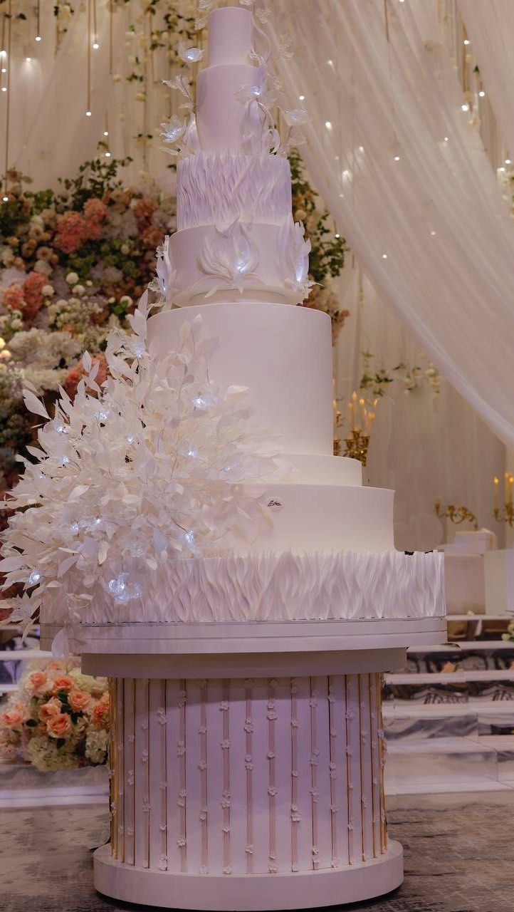 a large white wedding cake sitting on top of a table