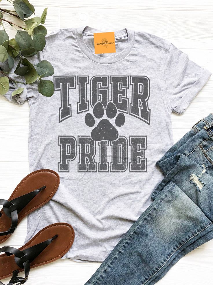 a t - shirt that says tiger pride with a paw print on the front and bottom