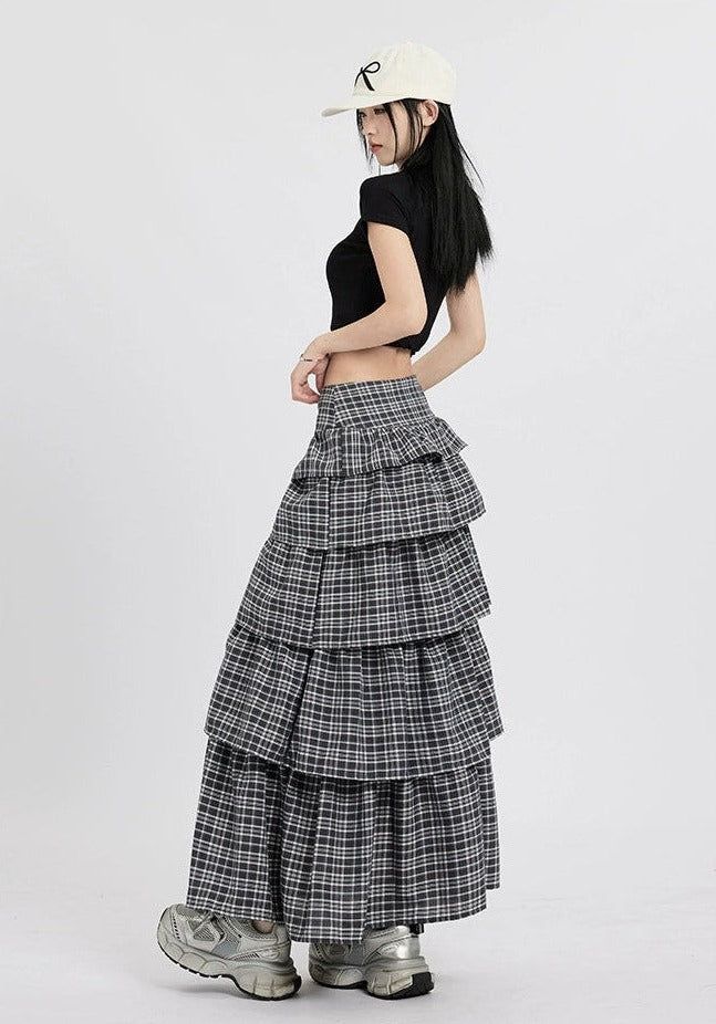 Channel understated chic with this Layered Plaid Maxi Skirt featuring delicate ruffle details.
Crafted from a comfortable blend of mainly cotton, this skirt showcases a multi-layered design that adds a playful twist to the classic plaid pattern. The high-waist cut ensures a flattering silhouette, while the versatile style makes it easy to dress up or down. It's a piece that carries a perfect balance of edgy and professional aesthetics.
Pair this skirt with a tucked-in graphic tee and sneakers fo Chic Cotton Ruffled Mini Skirt, Layered Long Skirt For Spring, Relaxed Cotton Mini Skirt With Ruffles, Cotton Ruffled Mini Skirt With Relaxed Fit, Cotton Tiered Mini Skirt With Lining, Chic Cotton Tiered Mini Skirt, Trendy Tiered Skirt With Ruffle Hem, Chic Tiered Maxi Skirt With Ruffle Hem, Chic Tiered Maxi Skirt With Layered Hem