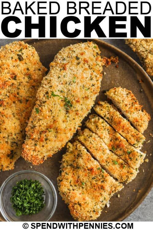 chicken tenders on a plate with parmesan and seasoning next to it