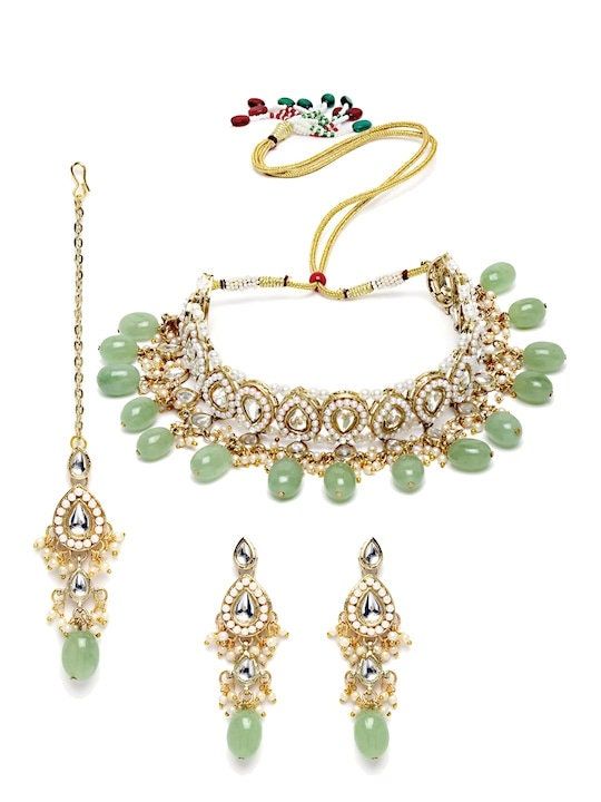 This jewelry set consists of a necklace, a pair of earrings The gold-plated necklace, has lime green stone and white kundan studded detail Secured with a drawstring closure A pair of matching drop earrings, each secured with post and back closure Comes with matching maang tikka Size & Fit Dimensions: Necklace: 23cm x 2.5cm (Length x Width) Earrings: 7cm x 2.5cm (Length x Width) Maangtikka: 7cm(Length) Material & Care Material: Alloy Plating: Gold-Plated Stone Type: Kundan Wipe with a clean cotton swab when needed Luxury Pista Green Cutdana Set, Luxury Green Jewelry With Stone Work, Luxury Green Cutdana Jewelry Sets, Luxury Green Jewelry Sets For Festivals, Luxury Handmade Green Jewelry Set, Luxury Green Bollywood Sets, Luxury Green Fusion Style Jewelry, Festive Luxury Green Kundan Necklace, Luxury Green Cutdana Necklace