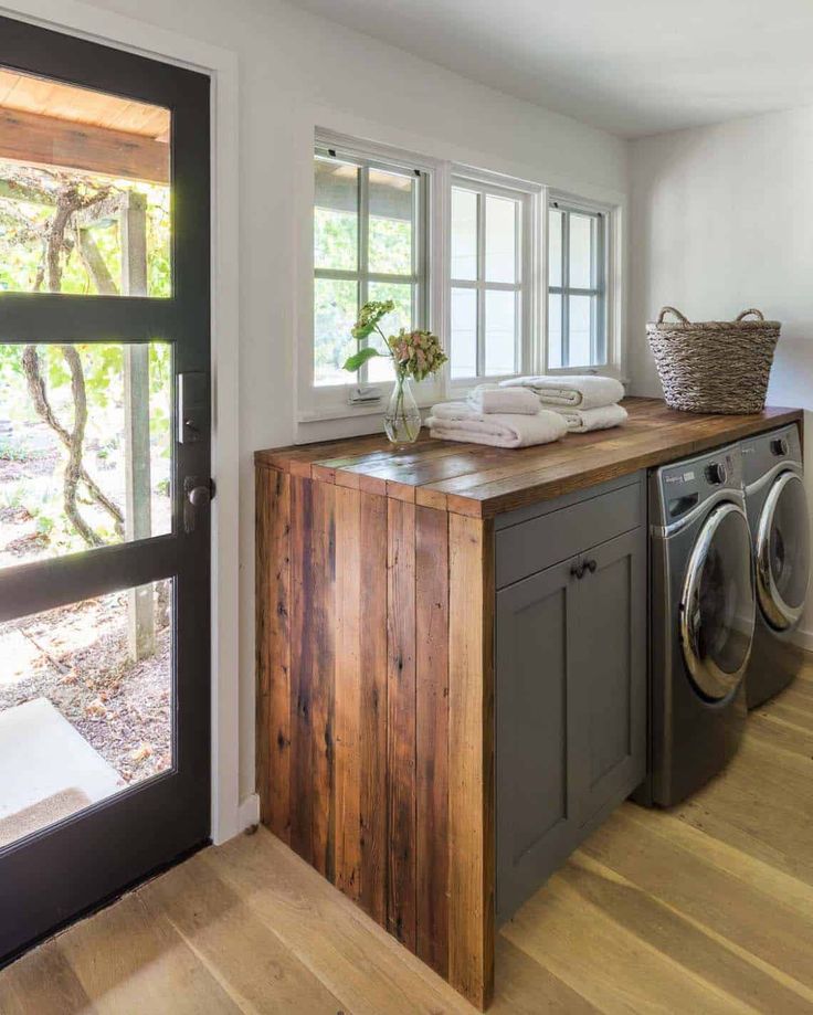 a washer and dryer in a room next to a window with an open door