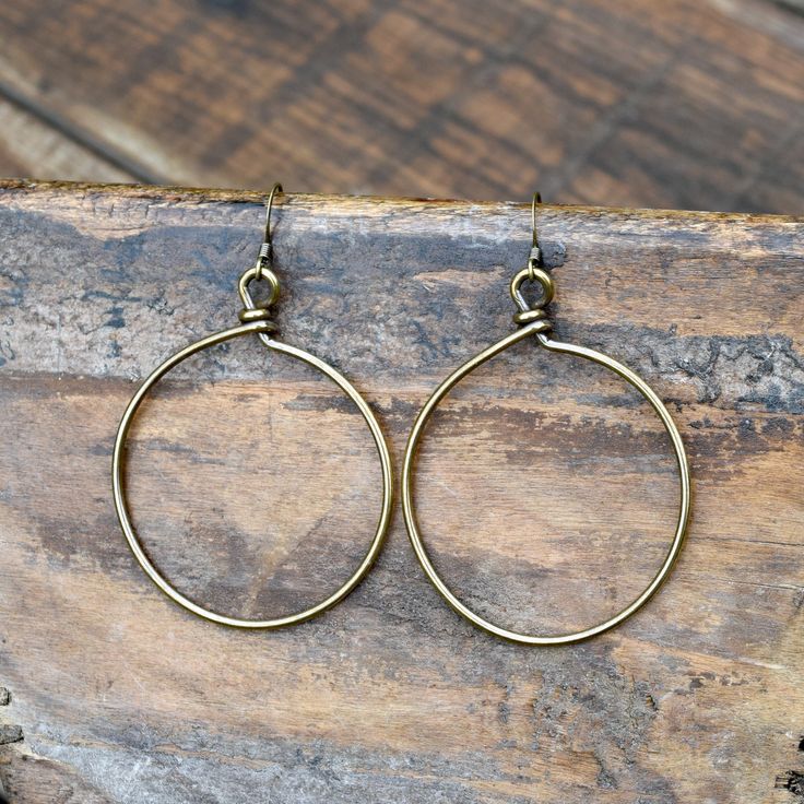 These are antiqued Gold wire wrapped hoop earrings on antiqued Gold ear wire. They hang approximately 2 1/2 inches. Bronze Wire Wrapped Hoop Earrings, Vintage Small Hoop Brass Earrings, Vintage Brass Small Hoop Earrings, Small Bronze Metal Hoop Earrings, Adjustable Brass Hoop Earrings With Ear Wire, Adjustable Brass Vintage Hoop Earrings, Adjustable Vintage Brass Hoop Earrings, Small Metal Hoop Earrings With Soldered Detail, Bronze Brass Wire Wrapped Hoop Earrings