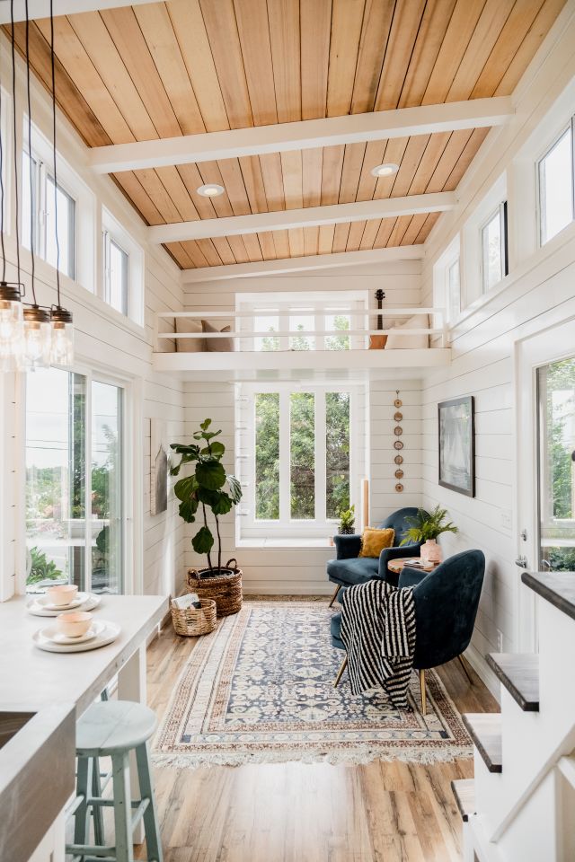 a living room filled with furniture and lots of windows