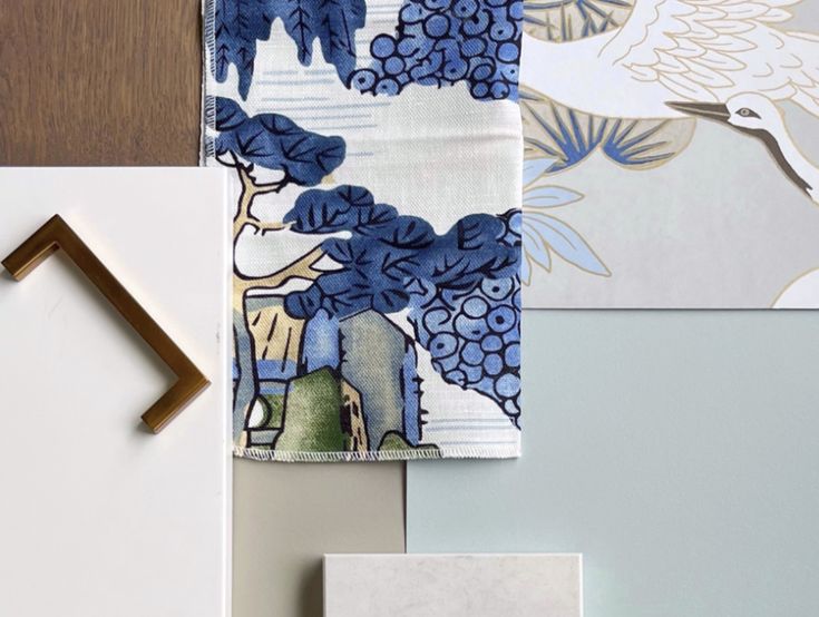 the table is covered with blue and white wallpaper, including two napkins that have birds on them