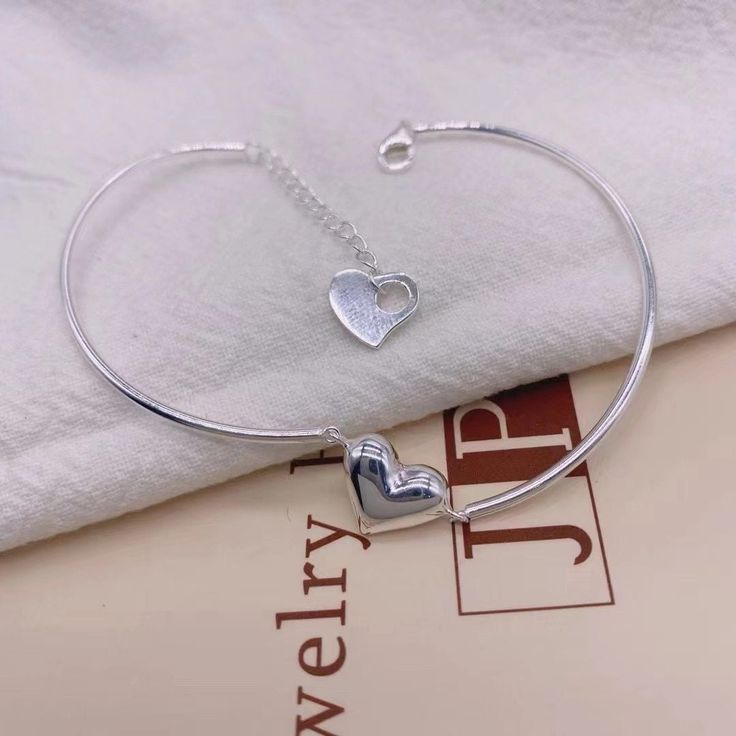 Bracelet with heart shape charm Silver Heart Charm Bracelet For Friendship, Heart Shaped Bracelet Strap Jewelry Gift, Metal Bracelets For Valentine's Day, Metal Round Bracelets For Valentine's Day, Silver Double Heart Bracelets For Valentine's Day, Heart Charm Bangle Bracelets For Friendship, Friendship Heart Charm Bangle Bracelet, Metal Heart Bracelet For Friendship, Heart-shaped Metal Bracelet For Friendship