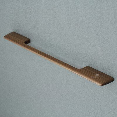 a wooden handle on a gray surface