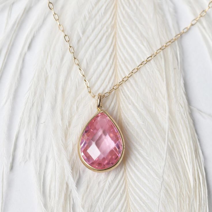 The Drop Pink Sapphire Necklace is a stunning piece that exudes elegance and charm. Featuring a teardrop CZ pink stone set in 14K gold, this pink sapphire necklace is perfect as a birthstone necklace. Its delicate and timeless design makes it an exquisite gift for a bride, ensuring she feels cherished on her special day. A beautiful addition to any jewelry collection, this necklace is sure to impress Dimension: Pendant High: 10mm / 0.38 inches Pendant Width: 6mm / 0.24 inches Product Features: * Solid Gold Chains, Christmas Gifts For Women, Sapphire Necklace, Pink Stone, Birthstone Necklace, Pink Sapphire, Gold Vermeil, Favorite Things List, Gold Chains