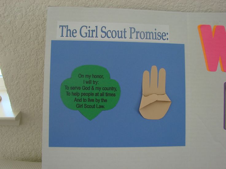 the girl scout is holding up her hand to say what she's going for