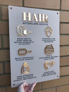 a hand holding up a sign that says hair after care advice on it's side