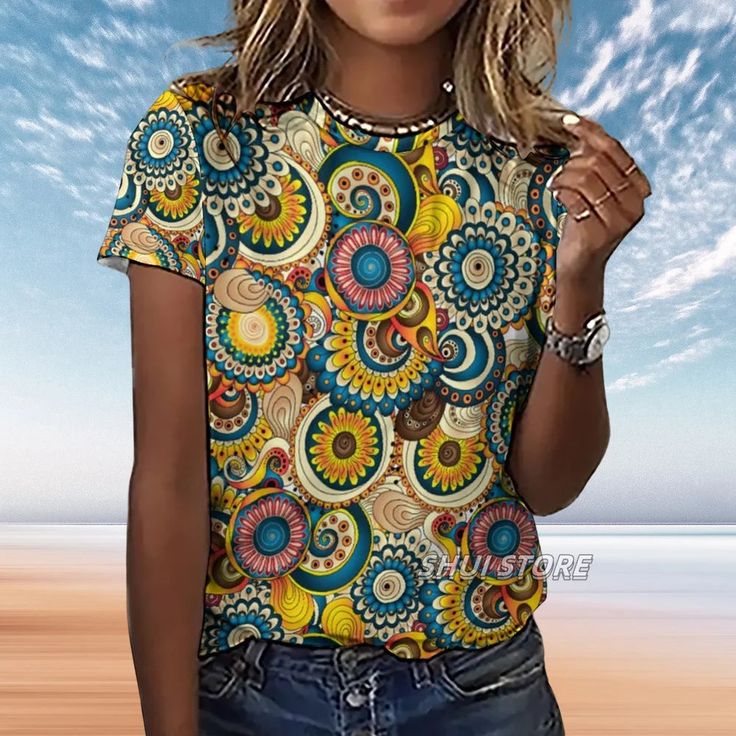 Unleash the vibrancy of your wardrobe with our Women's Full Mandala Patterned T-Shirt, a true embodiment of bohemian elegance. Each t-shirt is a canvas of rich, swirling colors and intricate mandala patterns that capture the essence of artistic freedom and the spirit of wanderlust. Made with premium quality fabric, these t-shirts ensure a comfortable and flattering fit, perfect for embracing the day-to-day with a touch of flair. The all-over mandala design resonates with those who find beauty in Bohemian Crew Neck T-shirt For Summer, Bohemian Short Sleeve Beach T-shirt, Hippie Multicolor T-shirt For Spring, Multicolor Bohemian T-shirt For Beach, Bohemian Graphic Print T-shirt For Summer, Bohemian Printed T-shirt For Spring, Multicolor Patterned T-shirt For Summer, Bohemian Multicolor Print Short Sleeve T-shirt, Bohemian Printed T-shirt For Festivals