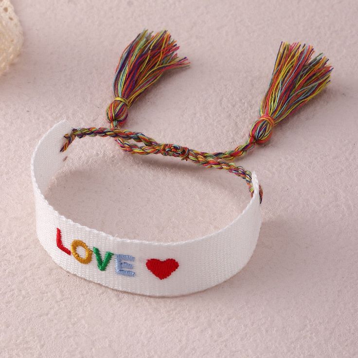 Add a pop of color to your wrist with our Embroidered Boho Tassel Bracelet. Handcrafted with intricate embroidery and stylish tassels, this bracelet is a perfect addition to your boho-chic collection. Shop now and elevate your accessory game with this stylish and trendy bracelet. Bohemian Bracelets With Tassels, Bohemian Embroidered Bracelets For Festivals, Bohemian Adjustable Embroidered Bracelets, Bohemian Embroidered Adjustable Bracelets, Bohemian Woven Bracelets For Vacation, Bohemian Embroidered Friendship Bracelets For Festivals, Adjustable Embroidered Bohemian Friendship Bracelets, Bohemian Multicolor Embroidered Friendship Bracelets, Adjustable Embroidered Multicolor Bracelets