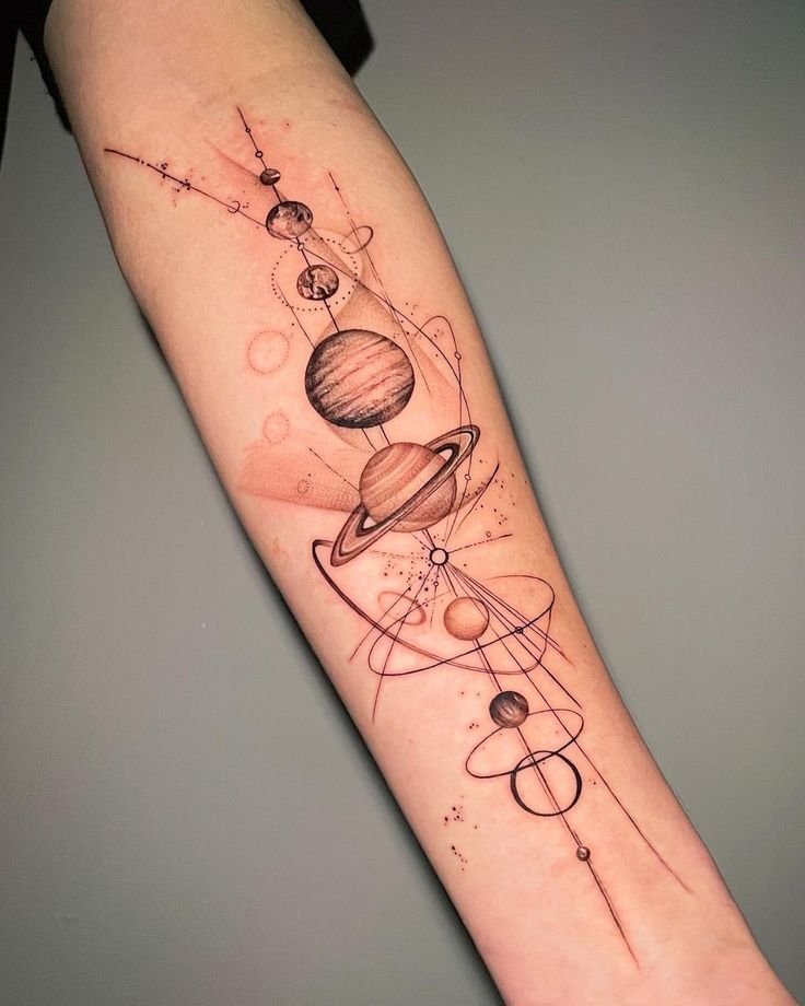 an arm tattoo with the planets and stars on it, as well as some circles