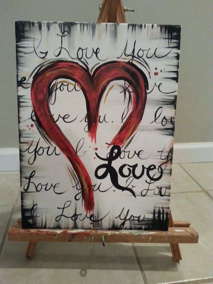 an easel with a painting on it that says i love you and two hearts