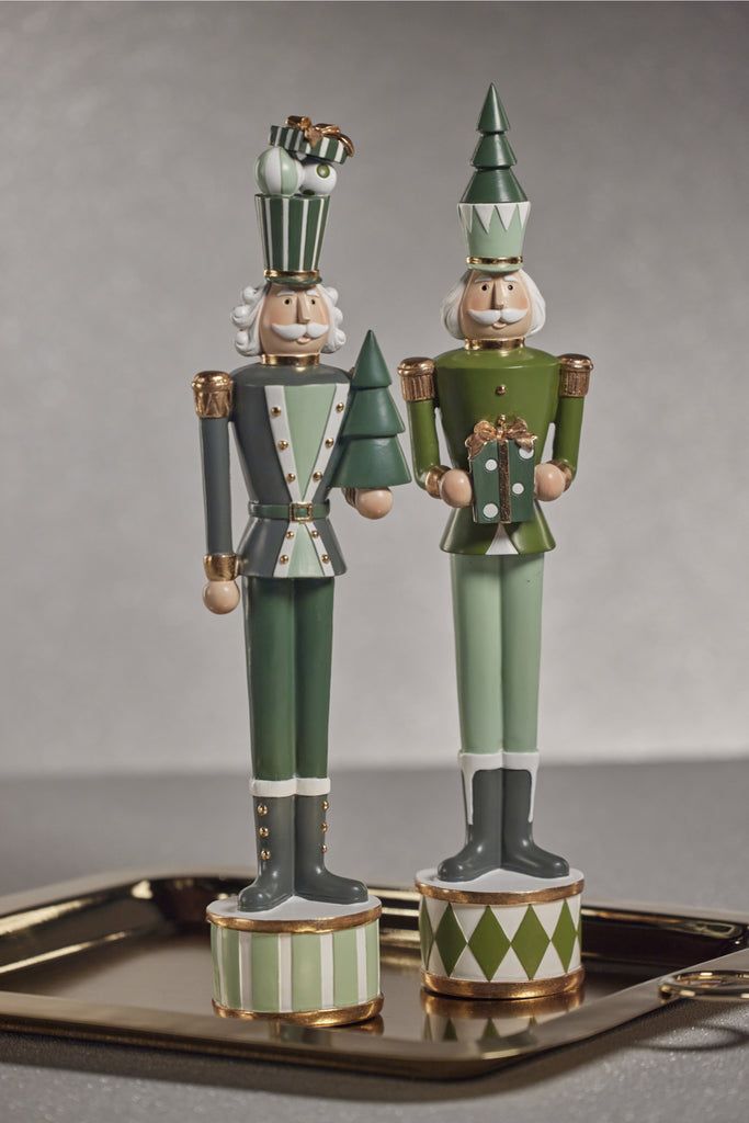 two nutcrackers are standing on a tray