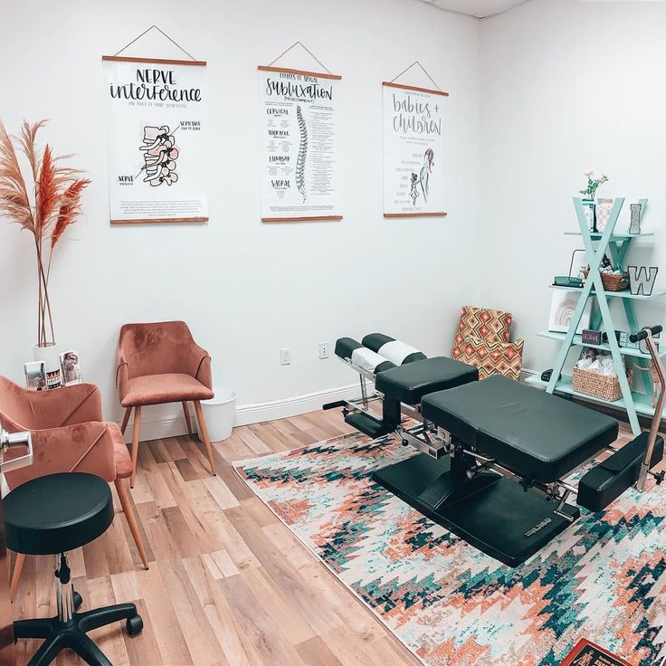 a salon with chairs, rugs and posters on the wall