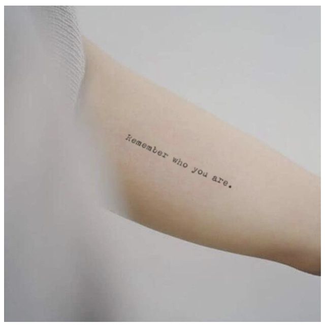 a person with a tattoo on their arm that says, remember who you are