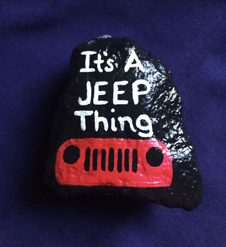 a rock with the words it's a jeep thing painted on it, sitting on a blue background