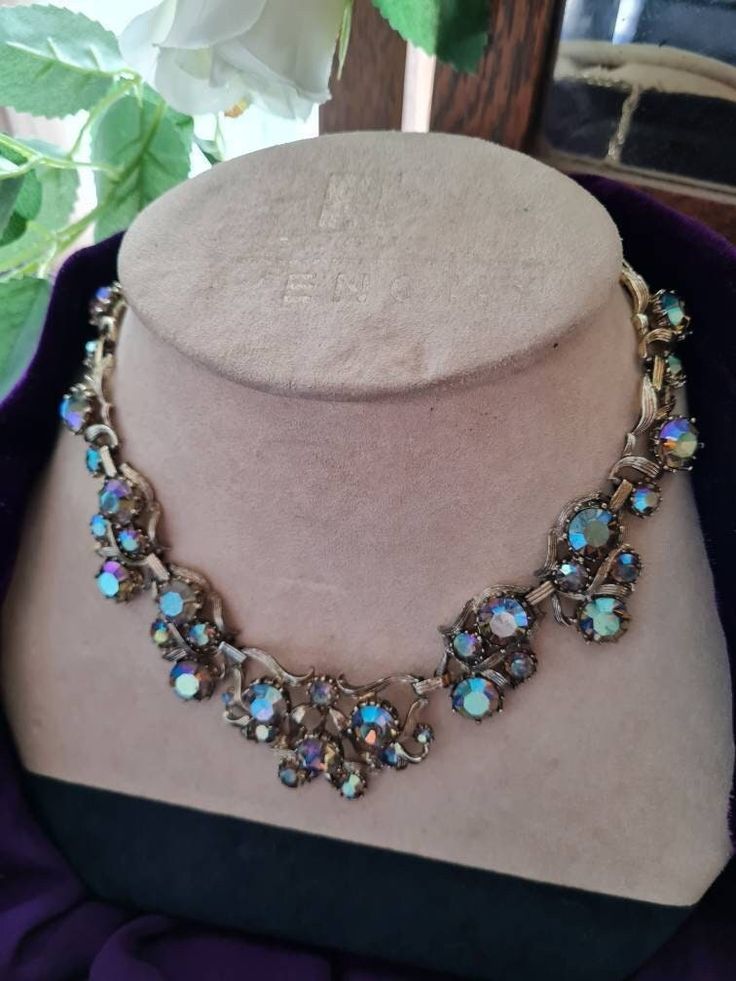 Stunning sparkly multi coloured rainbow rhinestone/cut glass necklace choker 1950s 60s era Chunky statement necklace Purple/green/blue, iridescent shimmery sparkly necklace inset in gold metal In good pre-loved condition with normal signs of wear due to age Goldtone backing and clasp fastening  Sits just below collar position Measures:approximately  All orders are shipped using biodegradable and recycled packaging where possible Vintage Jeweled Choker For Parties, Vintage Sparkling Stones Necklaces For Party, Vintage Crystal Necklaces For Party, Iridescent Crystal Necklaces For Party, Vintage Crystal Choker Jewelry, Vintage Crystal Jeweled Necklaces, Vintage Rhinestone Crystal Choker Necklace, Vintage Crystal Rhinestone Choker Necklace, Vintage Rhinestone Choker For Party