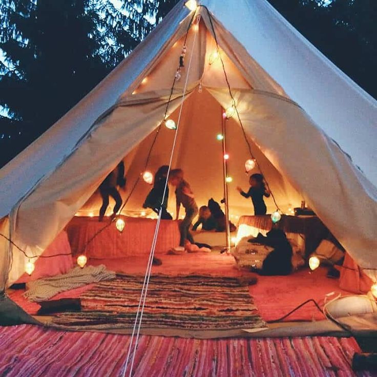 a white tent with lights and people in it