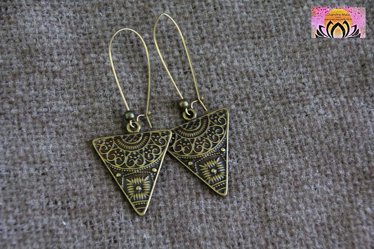 LARGE BRONZE TRIANGLE EARRINGS                                                             This pair of earrings was crafted with Antique Bronze. It features a triangle, ethnic charm. You can choose from LONG ear wires and SHORT ear wires, using the scroll down menu. On the LONG hooks, the earrings are 70mm long in total. On the SHORT hooks, the earrings are 52mm long in total. Beads Size and Material: Antique Bronze charm 35mm x 28mm Iron Hooks in Bronze Tone, nickel and cadmium free TO SEE MOR Bohemian Triangle Adjustable Earrings, Bohemian Adjustable Triangle Earrings, Adjustable Bohemian Triangle Earrings, Handmade Triangle Bohemian Jewelry, Handmade Bohemian Triangle Jewelry, Bohemian Triangle Nickel-free Earrings, Nickel-free Triangle Bohemian Jewelry, Handmade Triangle Brass Jewelry, Bohemian Triangle Nickel-free Jewelry