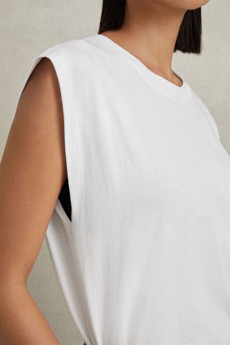 Find REISS Morgan Cotton Capped Sleeve T-shirt on Editorialist. The Morgan T-shirt is made from 100% cotton and designed with a fashioning seam to the reverse. Its lightweight shape is relaxed with capped sleeves and a crew neckline. 100% cotton Crew neckline Capped sleeves Fashioning seam to reverse White Crew Neck Cotton Tank Top, White Cotton Crew Neck Tank Top, Summer Cotton Tops With Dropped Armholes, Summer Muscle Tee With Dropped Armholes, Spring Relaxed Fit Tank T-shirt, White Crew Neck Tank Top For Layering, Summer Cotton Crew Neck Muscle Tee, Relaxed Fit Cotton Tank T-shirt, Summer Crew Neck Cotton Muscle Tee