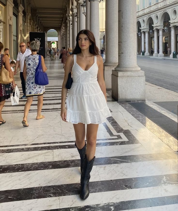 White Dress Black Boots Aesthetic, Dresses With Boots Summer, Minimalist Cowboy Boots Outfit, White Mini Dress And Cowboy Boots, Mini Dress And Cowboy Boots Outfit, White Cowboy Boots Outfit Aesthetic, Dress Boots Outfit Summer, Dress With Black Cowgirl Boots, Black Cowboots Outfits