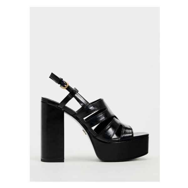 High heel platform sandals. Buckled ankle strap closure. Squared toes. Heel height: 5.5 inches (14 cm)