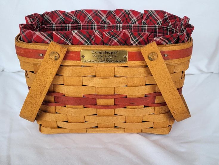 a wooden basket with red and black plaid lining