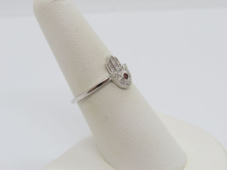 Vintage Sterling Silver Garnet & White Topaz Hamsa Ring ....Marked 925...Total of weights 1.7grams...Size 7...Measure of Face 10.9MM...It's in very good condition. White Gold Sterling Silver Ruby Ring With Diamond Accents, Hand Set Sterling Silver Diamond Ring, Hand Set Sterling Silver Promise Ring, Silver Ruby Ring With Diamond Accents As Gift, Silver Ruby Ring With Diamond Accents, Hamsa Ring, White Topaz, Stackable Rings, Ring Holder