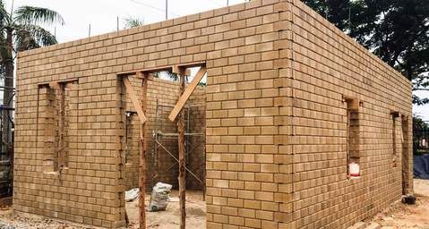 a brick house being built with wooden framing