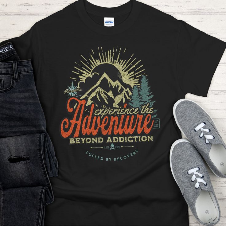 This Recovery T-Shirt encourages sobriety with a design featuring mountains and other outdoor elements, inspiring you to experience the adventure beyond addiction. Fueled by recovery, this T-Shirt is for anyone who wants to celebrate their journey of sobriety. 100% cotton (99/1 cotton/poly (Ash) & 90/10 cotton/poly (Sport Grey), 50/50 cotton/poly (Dark Heather) Heavyweight classic unisex tee Taped neck and shoulders; Tearaway label Made with sustainably & fairly grown USA cotton Print Method: DI Black T-shirt For Hiking With Letter Print, Black Letter Print T-shirt For Hiking, Black Hiking T-shirt With Letter Print, Black Graphic Tee For Camping, Black T-shirt With Screen Print For Adventure, Black Screen Print T-shirt For Adventure, Black Graphic Print T-shirt For Adventure, Black Graphic Print T-shirt For Camping, Black Graphic Print T-shirt For Outdoor