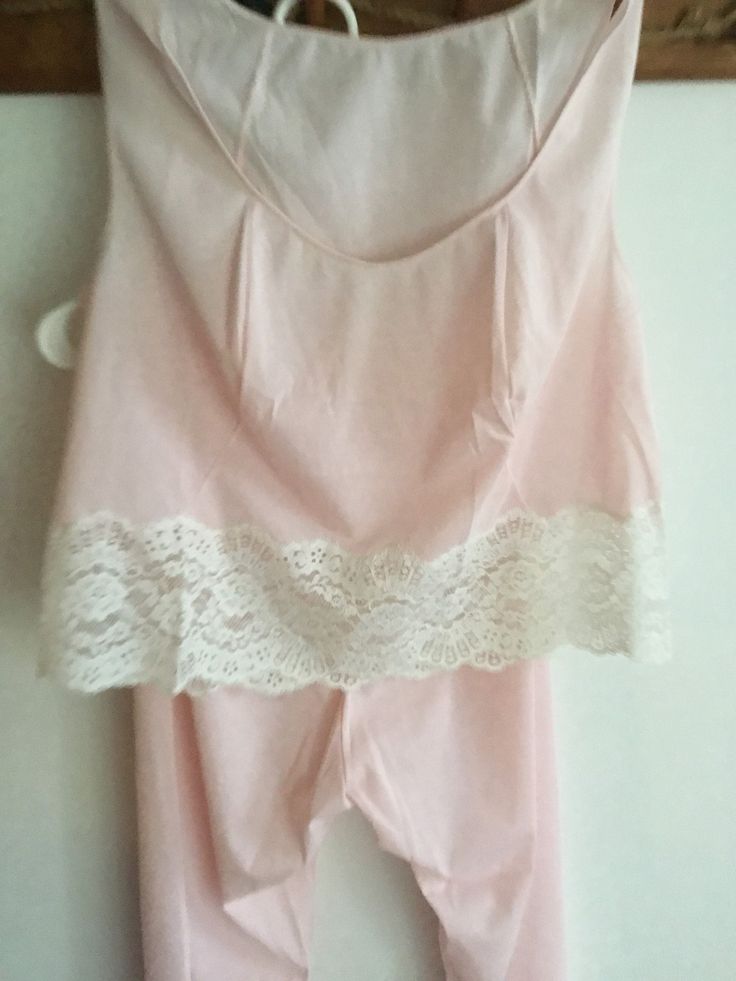 True Vintage 1950's Pretty pink pajama set by Vanity Fair. Tagged Size 36 which appears to be a small or maybe medium.  Please use measurements.  Short top with lace trim Elastic waist bottoms Sheer Nylon Tricot - appear unused though there are some pink pricks to the top at shoulder seams - possibly an alteration that was let out - small but there.  Bust is 19 inches Length of top is 19 inches Bottoms waist is 12-19 inches with stretch Rise is 14 inches 36 inches long Inseam is 24 inches Please Fitted Lace Trim Sets For Pajama Party, Fitted Lace Trim Sleepwear Set, Pink Fitted Matching Set Sleepwear, Fitted Pink Matching Set Sleepwear, Pink Stretch Bedtime Sets, Pink Sleeveless Top Matching Set, Pink Sleeveless Matching Set Top, Fitted Lace Trim Loungewear Set, Cotton Loungewear Sets With Lace Trim