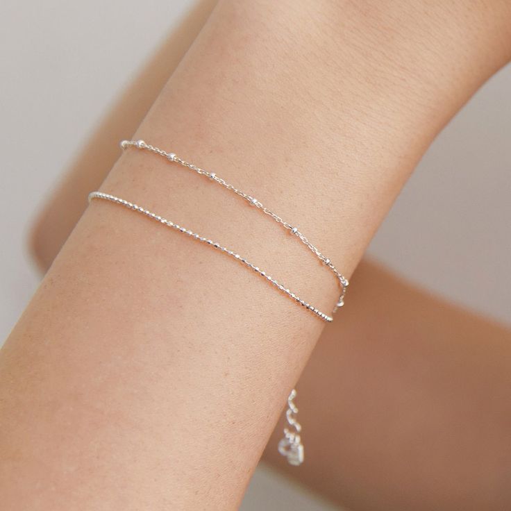 Dainty Duo Satellite Chain Bracelet, Delicate Silver Ball Chain Bracelet, Minimalist Bead Bracelet,Perfect Birthday Gift for Her (BR1804) ▶ Product Info. - Material: 925 Sterling Silver / Cubic Zirconia  - Metal Finish: 14K Gold / Silver + Anti-Tarnish E-Coat  - Safety: Nickle & Lead free and Haypoallergenic - Dimensions: Cubic Zirconia - 3.5mm - Length: 16cm + 3cm (length adjustable) - Weight: 1.2g - TATIANA & Silver 925 engraved tag was added. - Made In South Korea ♡Set of 2 Bracelet with only one Closure. Our jewelry was plated with a hight-content gold/silver layer to minimize the discoloration, compared to regular non-plating one. ▶Shipping and Return Policies Order today to get by Date (14days) Return & exchanges accepted within 30days Cost to ship : USD 7.00 ▶Cancellations Cancellat Double Ball Chain Bracelet, Delicate Silver Chain Bracelet As Gift, Delicate Silver Bracelet For Anniversary, Silver Minimalist Bracelet Jewelry, Dainty Silver Bracelets For Anniversary, Elegant Silver Beaded Bracelets With Delicate Chain, Delicate Silver Charm Bracelet As Gift, Minimalist Silver Bracelet Jewelry, Classic Silver Beaded Bracelets For Anniversary