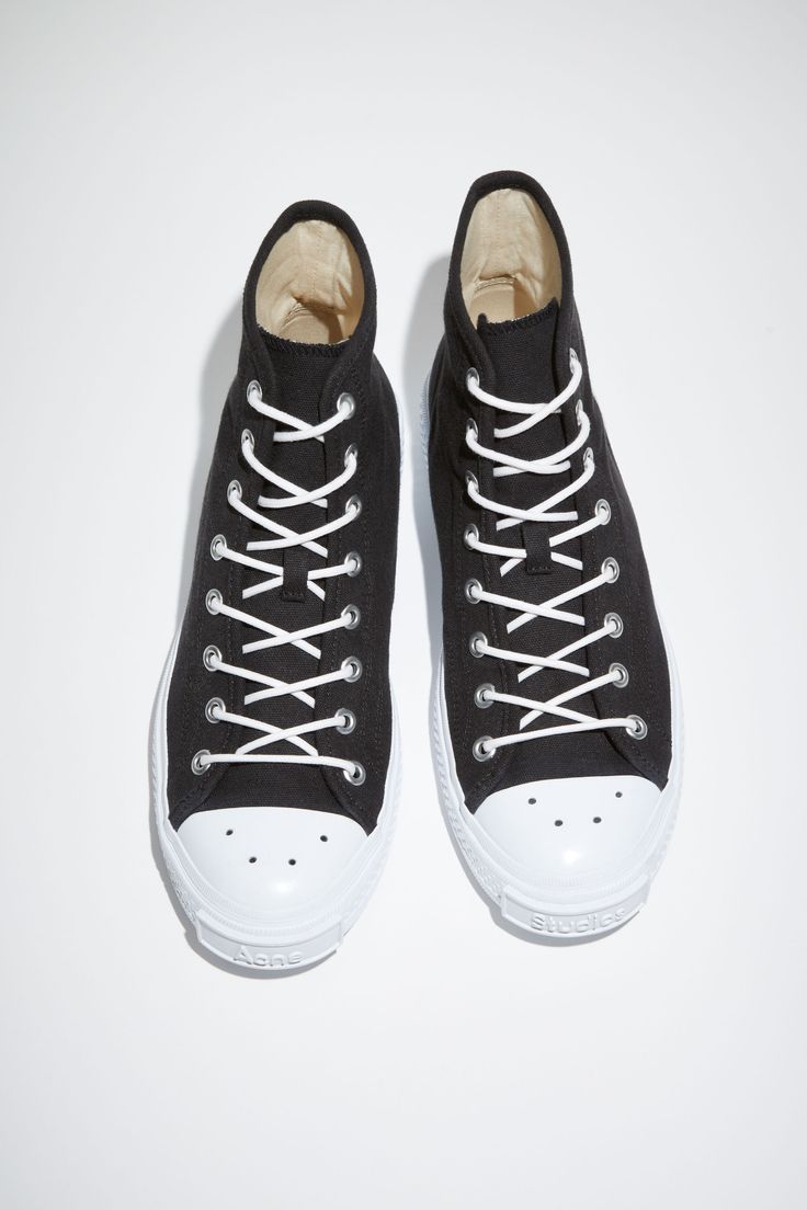 Acne Studios black/off white high top sneakers are crafted from organically grown cotton with rubber soles. Completed with a branded logo tag on the front. Ballow High Tag M Sporty Custom Cotton Sneakers With Rubber Sole, Black Cotton Canvas Shoes With Vulcanized Sole, Canvas High-top Sneakers With Rubber Sole, Streetwear Cotton Canvas Shoes With Contrast Sole, Custom Cotton Lace-up Sneakers With Rubber Sole, Cotton Canvas Shoes With Contrast Sole For Streetwear, Mid-top Canvas Shoes With Contrast Sole, Cotton Lace-up Canvas Shoes With Contrast Sole, Black Cotton High-top Sneakers