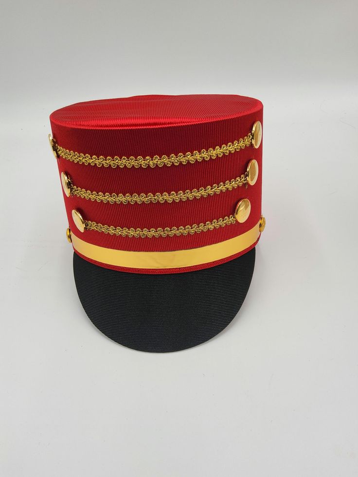 The Nicky Bigs Novelties™ ADULT TOY SOLDIER HAT Become the Toy Soldier, or the Band Leader in the Parade! Select from a Blue, Black, or Red hat featuring gold accents. Each hat is comfortable and lightweight. Great for Halloween, Cosplay, Theater and more! Perfect accessory for Nutcracker, Conductor, Toy Soldier, Band Leader and more! Hat stands approximately 5" tall and fits approximately 58 cm, 7-1/4 American 7-3/8 European. ⭐ Adult Toy Soldier Hat. Select from Blue/Red, Red/Black, and Black. ⭐Each hat features gold trim strips and button accent.  Perfect for Men, Women, and Teens! ⭐Lightweight and comfortable to wear! Each cosplay hat stands approximately 5" tall. ⭐Sized approximately 58 cm or 22.8 inches in circumference.  ⭐Each hat is made of Polyester fabric with a Cardboard frame fo Adjustable Red Hat For Costume Party, Red Adjustable Hat For Costume Party, Novelty Red Hat Costume Accessories, Red Novelty Hat Costume Accessories, Red Novelty Costume Hat, Red Themed Costume Accessories For Gifts, Red Themed Costume Accessories For Gift, Themed Red Costume Accessories For Gift, Themed Red Costume Accessories As Gift