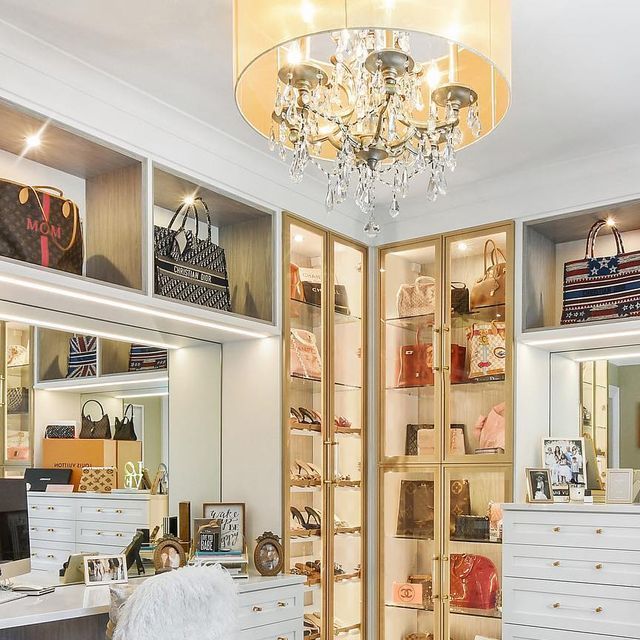 the closet is full of purses and handbags, including one that has a chandelier