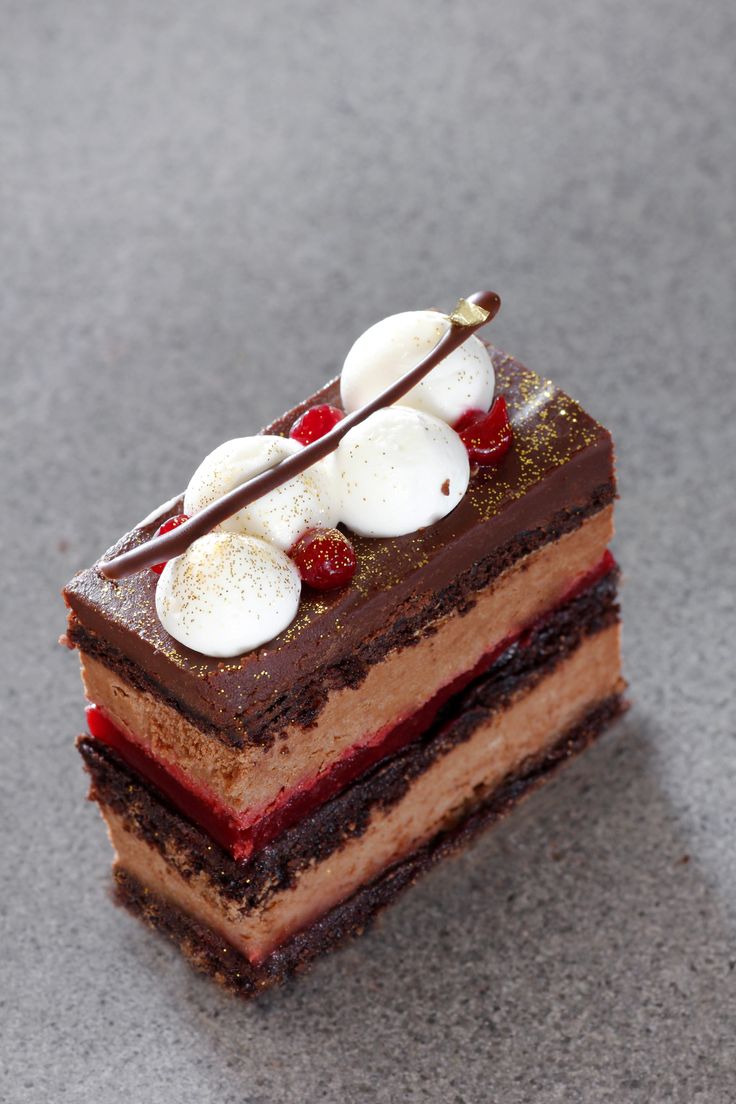 a piece of chocolate cake with cherries on top