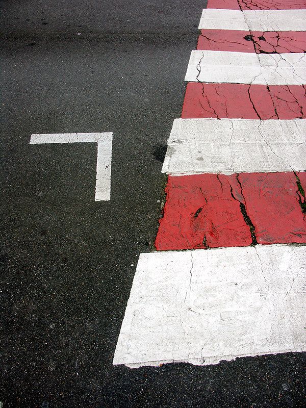 a red and white cross walk painted on the street