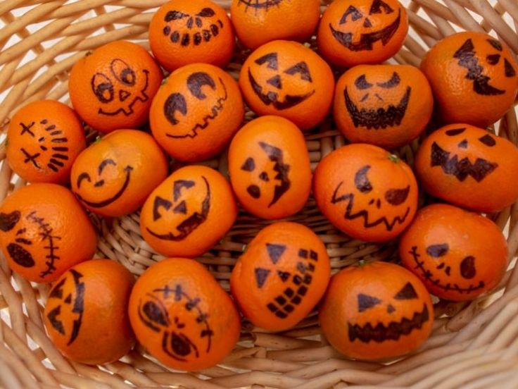 a basket filled with orange painted pumpkins on top of a green and blue frame