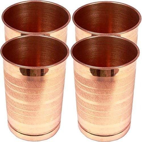 four copper colored metal cups sitting next to each other