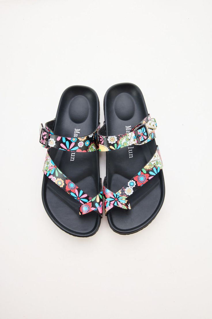 Step into comfort and style with Maibulun Thong Toe Cushioned Footbed Sandals. Designed with a cushioned footbed and thong toe, these sandals provide the perfect blend of support and style. The multi tropical prints adds a pop of color to any outfit, making these sandals a versatile addition to your wardrobe. 0.59" inch heel Slip-on / buckle closure Soft Cushioned footbed Man-made leather upper Man-made lining PU sole Leather Footbed Toe Loop Flip Flops For Beach, Toe Loop Flip Flops With Leather Footbed For Beach, Beach Toe Loop Sandals With Textured Footbed, Comfortable Beach Footbed Sandals With Single Toe Strap, Comfortable Toe Loop Footbed Sandals For The Beach, Summer Flip Flops With Textured Footbed And Toe Loop, Summer Toe Loop Flip Flops With Textured Footbed, Spring Beach Footbed Sandals With Single Toe Strap, Beach Footbed Sandals With Textured Footbed