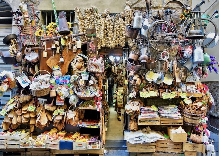 two shelves filled with lots of different types of items and baskets on top of each shelf