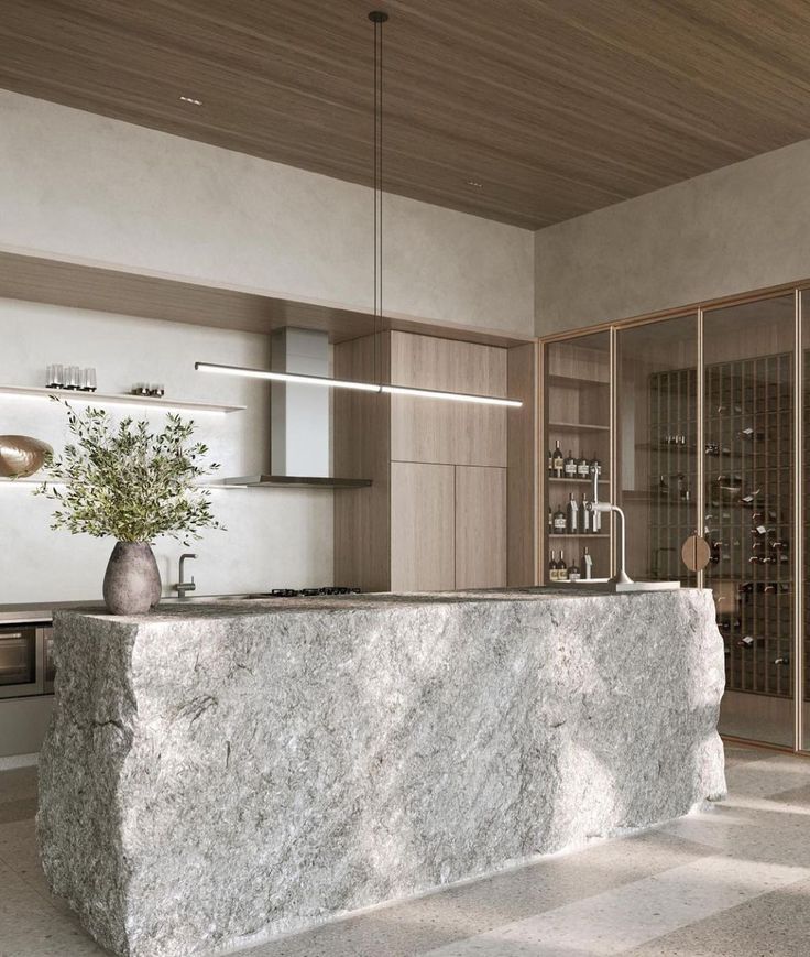 a kitchen with a marble counter top and wooden ceiling