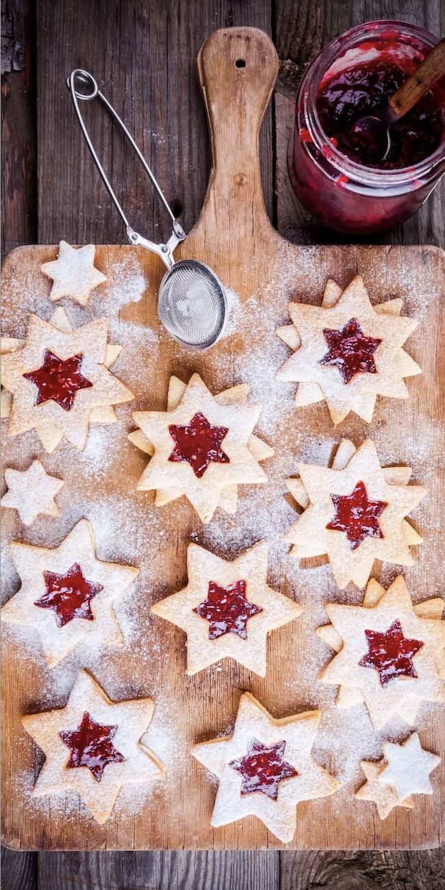 some cookies are on a cutting board with jam