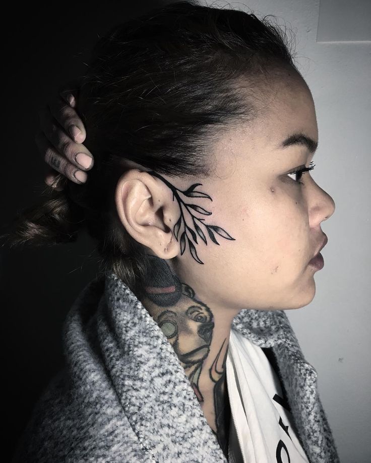 a woman with tattoos on her face and neck